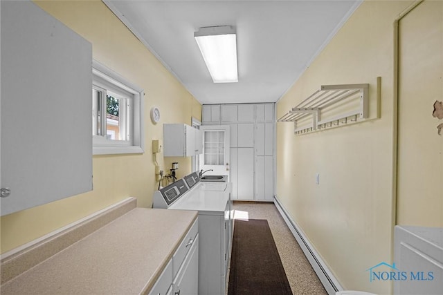 699 N Toussaint S Rd, Oak Harbor, OH 43449 - kitchen featuring independent washer and dryer, baseboard heating, light countertops, and crown molding