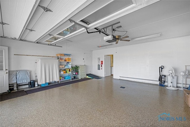 699 N Toussaint S Rd, Oak Harbor, OH 43449 - garage featuring a garage door opener and baseboard heating