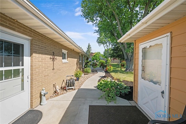 699 N Toussaint S Rd, Oak Harbor, OH 43449 - view of property exterior featuring brick siding and a patio