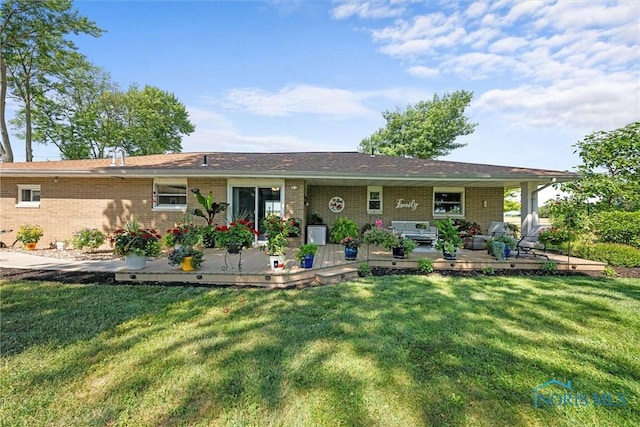 699 N Toussaint S Rd, Oak Harbor, OH 43449 - back of property with brick siding, a yard, and a wooden deck