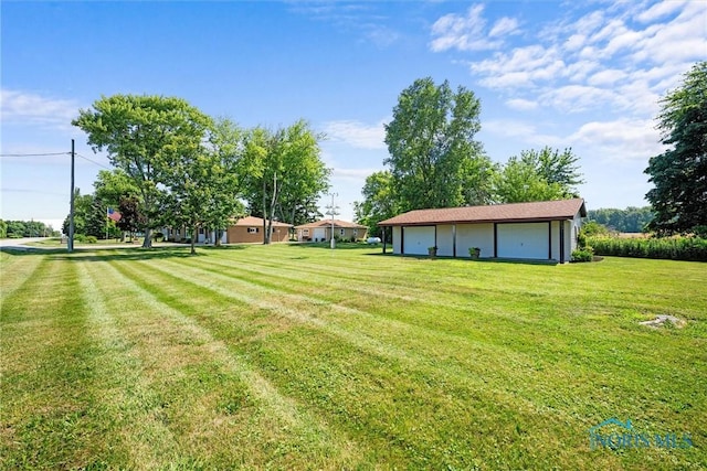 699 N Toussaint S Rd, Oak Harbor, OH 43449 - view of grassy yard with a detached garage and an outdoor structure
