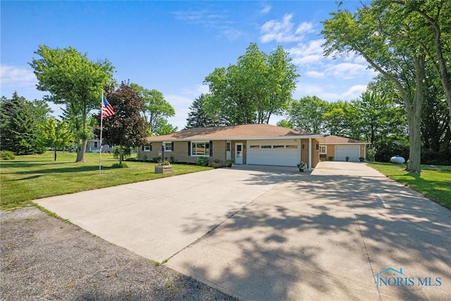 699 N Toussaint S Rd, Oak Harbor, OH 43449 - ranch-style house featuring a garage, driveway, and a front yard