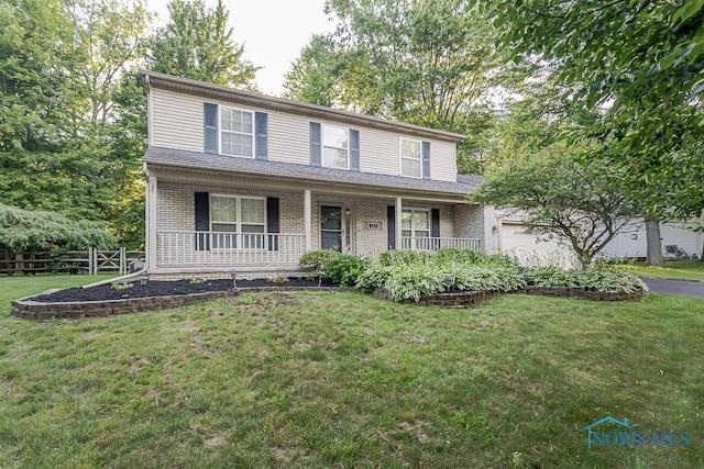 820 Weatherstone Rd, Holland, OH 43528 - traditional-style home featuring a garage, brick siding, covered porch, and driveway