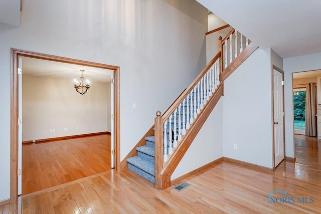 820 Weatherstone Rd, Holland, OH 43528 - staircase with hardwood / wood-style flooring and a chandelier