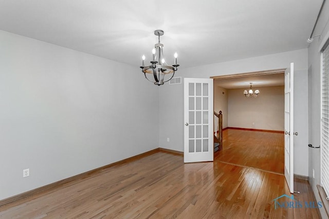 820 Weatherstone Rd, Holland, OH 43528 - spare room with a chandelier and light wood-style floors