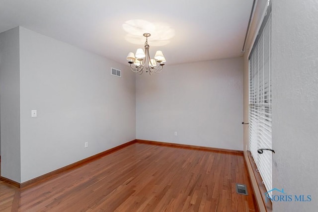 820 Weatherstone Rd, Holland, OH 43528 - empty room with light wood finished floors and a chandelier