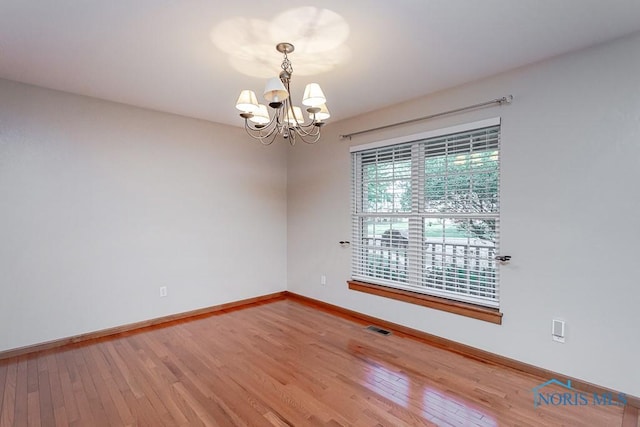 820 Weatherstone Rd, Holland, OH 43528 - spare room featuring a chandelier and hardwood / wood-style flooring
