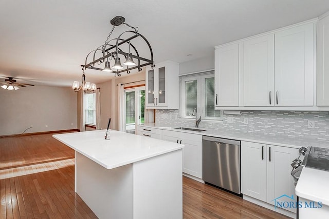 820 Weatherstone Rd, Holland, OH 43528 - kitchen featuring dishwasher, a center island, decorative backsplash, dark wood finished floors, and white cabinetry