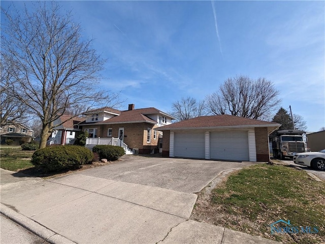 301 E Bigelow St, Upper Sandusky, OH 43351 - view of front facade featuring a garage and brick siding