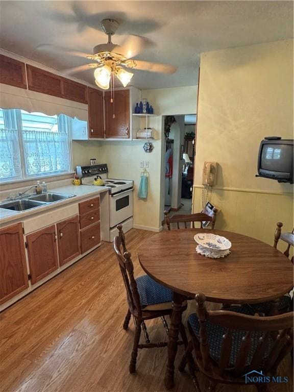 520 W Main St, Leipsic, OH 45856 - kitchen featuring electric range, light wood-type flooring, a ceiling fan, light countertops, and open shelves
