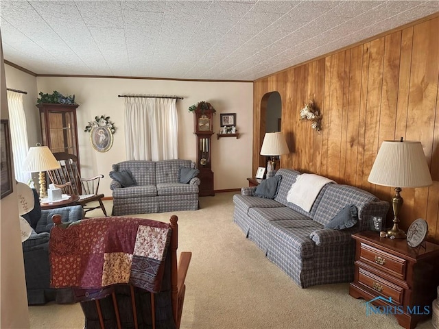 520 W Main St, Leipsic, OH 45856 - carpeted living room with wooden walls, ornamental molding, and arched walkways