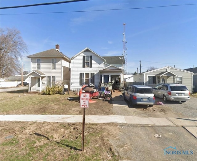 247 Crystal Ave, Findlay, OH 45840 - view of front of house featuring a chimney