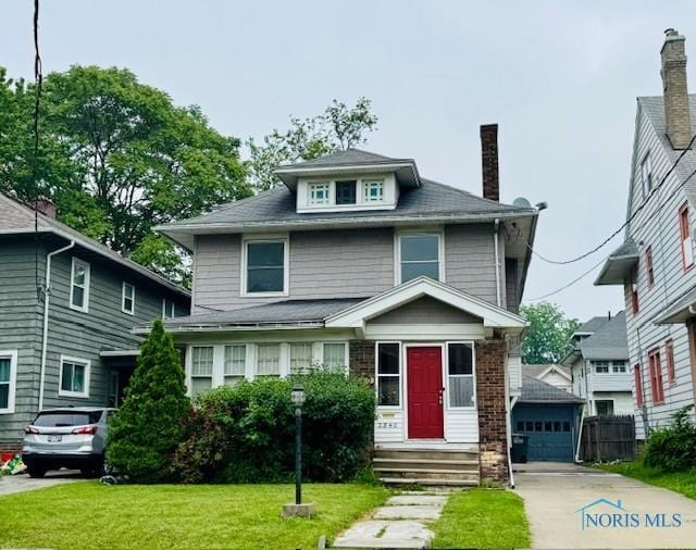 2840 Scottwood Ave, Toledo, OH 43610 - traditional style home featuring a front yard, a chimney, and a garage