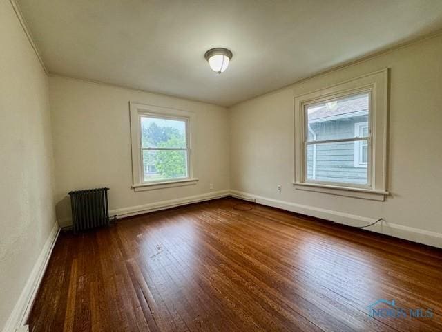 2840 Scottwood Ave, Toledo, OH 43610 - unfurnished room featuring radiator and dark wood finished floors