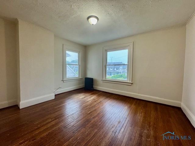 2840 Scottwood Ave, Toledo, OH 43610 - spare room with wood-type flooring and a textured ceiling