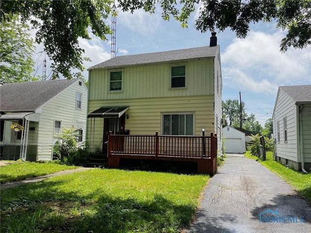 539 W Poinsetta Ave, Toledo, OH 43612 - rear view of house with a chimney, a detached garage, an outdoor structure, a deck, and a yard