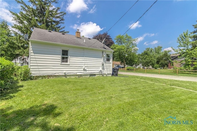 926 Searles Rd, Toledo, OH 43607 - view of home's exterior featuring a chimney and a yard