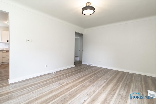 926 Searles Rd, Toledo, OH 43607 - unfurnished room with light wood finished floors and baseboards