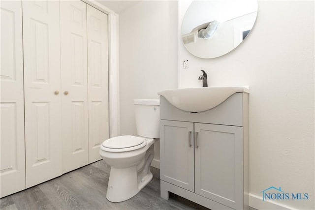 926 Searles Rd, Toledo, OH 43607 - bathroom featuring a closet, vanity, and wood finished floors