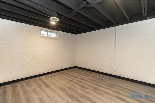 926 Searles Rd, Toledo, OH 43607 - below grade area featuring wood finished floors and concrete block wall