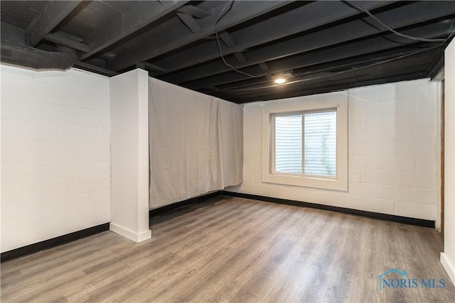 926 Searles Rd, Toledo, OH 43607 - below grade area featuring wood finished floors and concrete block wall