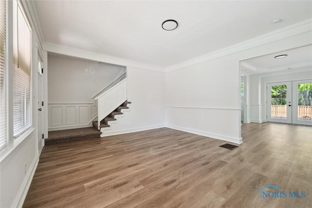 3627 Burton Ave, Toledo, OH 43612 - spare room with stairs, french doors, wood finished floors, and ornamental molding