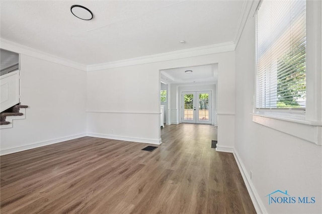 3627 Burton Ave, Toledo, OH 43612 - unfurnished living room with crown molding, wood finished floors, and stairway