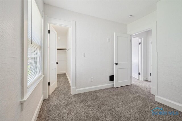 3627 Burton Ave, Toledo, OH 43612 - unfurnished bedroom featuring carpet floors and a walk in closet
