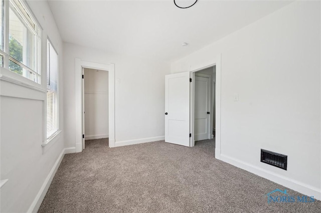 3627 Burton Ave, Toledo, OH 43612 - unfurnished bedroom with carpet flooring, multiple windows, and a closet