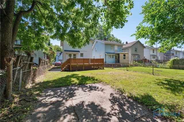 3627 Burton Ave, Toledo, OH 43612 - back of house featuring a fenced backyard, a wooden deck, a patio, and a residential view