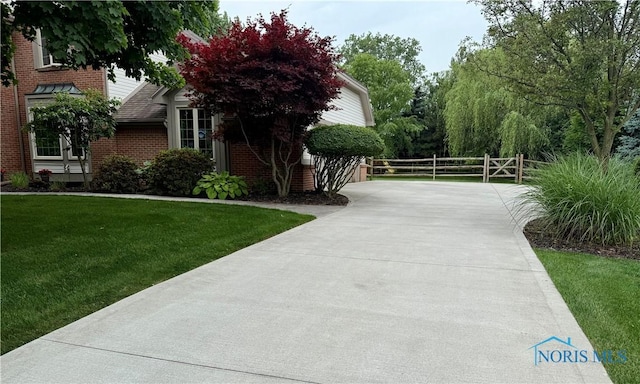 9627 Sheffield Rd, Perrysburg, OH 43551 - view of property exterior with a gate and brick siding