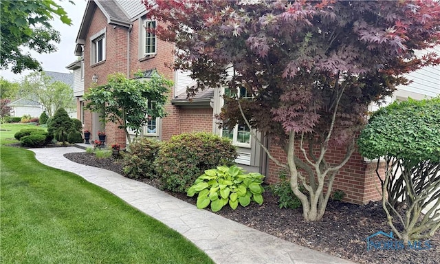 9627 Sheffield Rd, Perrysburg, OH 43551 - view of home's exterior with brick siding and a lawn
