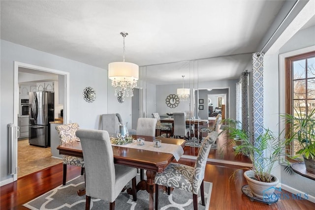 9627 Sheffield Rd, Perrysburg, OH 43551 - dining area with wood finished floors and a chandelier