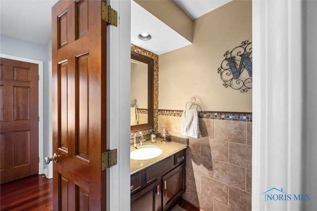 9627 Sheffield Rd, Perrysburg, OH 43551 - bathroom with tile walls, vanity, a wainscoted wall, and wood finished floors