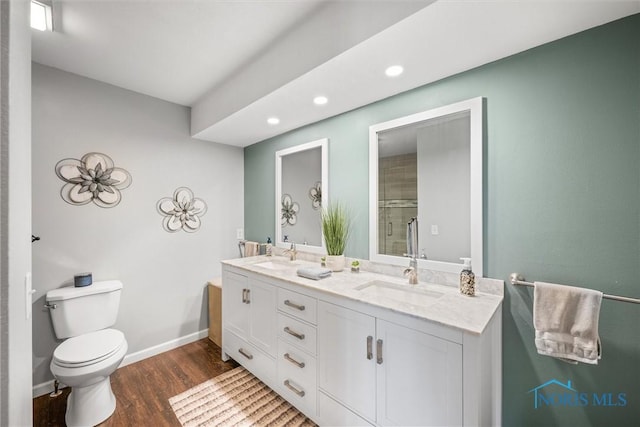 9627 Sheffield Rd, Perrysburg, OH 43551 - full bathroom with double vanity, wood finished floors, recessed lighting, and a shower with shower door