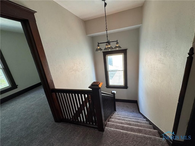 331 Buckeye St, Toledo, OH 43611 - stairway with carpet flooring, a chandelier, and a textured wall