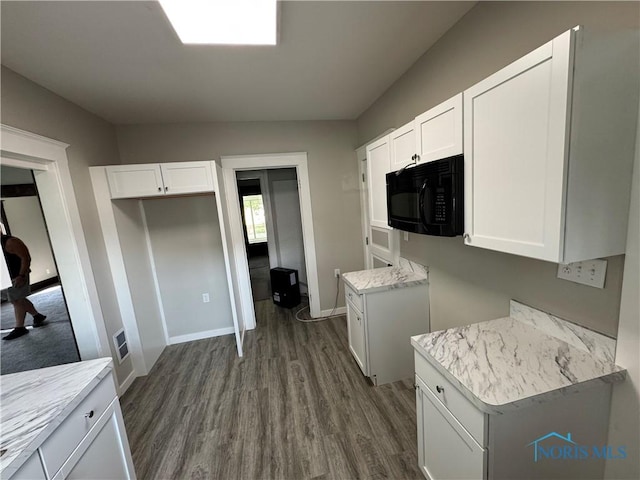 331 Buckeye St, Toledo, OH 43611 - kitchen featuring dark wood finished floors, black microwave, and white cabinetry