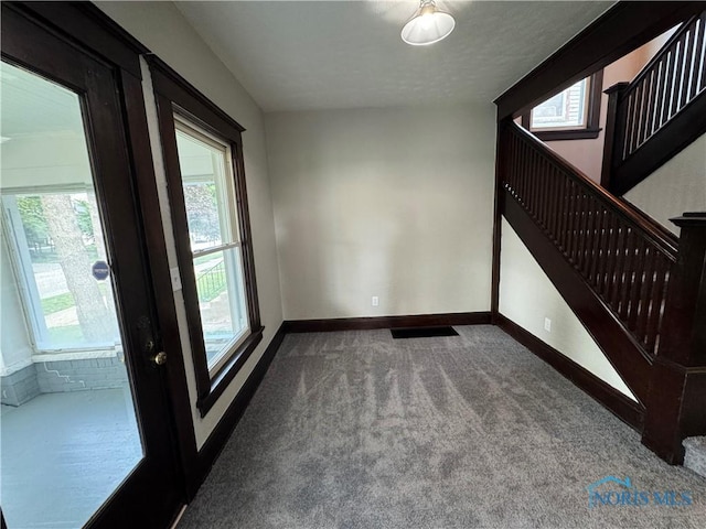 331 Buckeye St, Toledo, OH 43611 - spare room featuring carpet flooring, stairs, and plenty of natural light