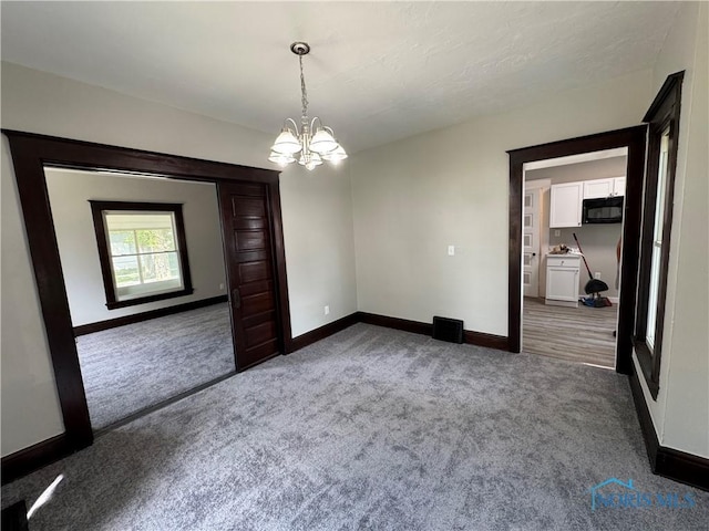 331 Buckeye St, Toledo, OH 43611 - spare room with carpet and a chandelier