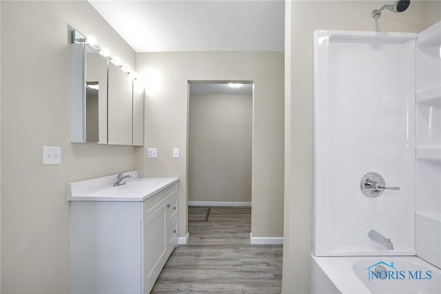 145 E Crocker St, Fostoria, OH 44830 - bathroom with vanity, wood finished floors, and shower / tub combination