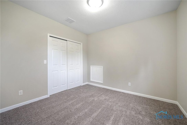 145 E Crocker St, Fostoria, OH 44830 - unfurnished bedroom featuring carpet flooring and a closet