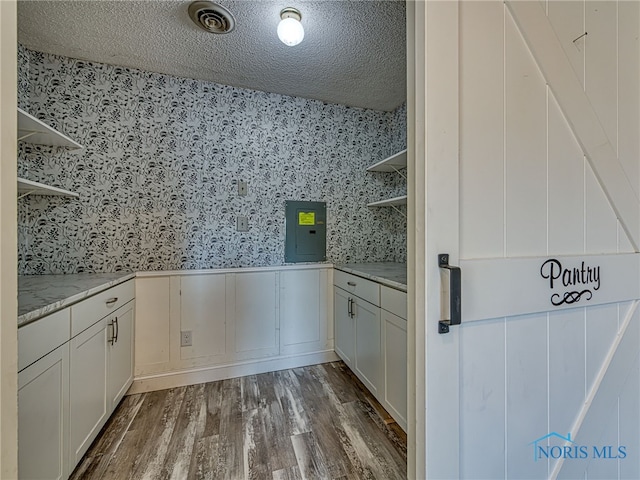 1323 Richland St, Maumee, OH 43537 - kitchen with open shelves, wallpapered walls, dark wood-type flooring, a textured ceiling, and white cabinets