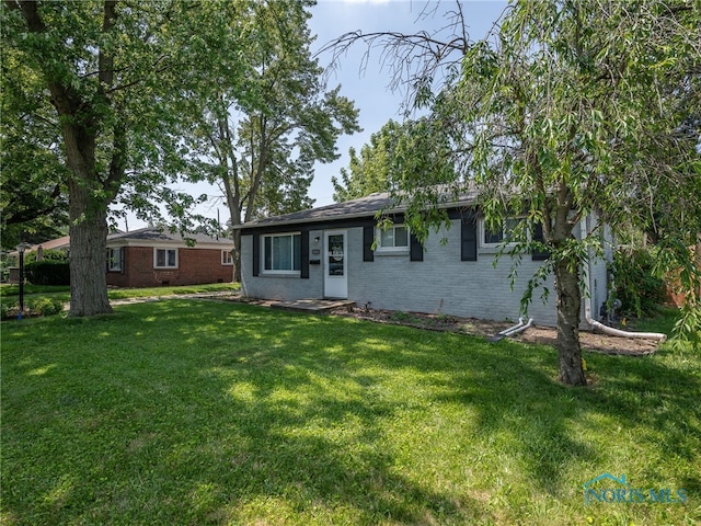 1323 Richland St, Maumee, OH 43537 - view of front of house with brick siding and a front yard