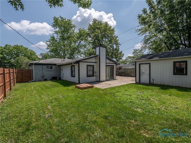 1323 Richland St, Maumee, OH 43537 - back of house featuring a fenced backyard, a patio area, and a chimney