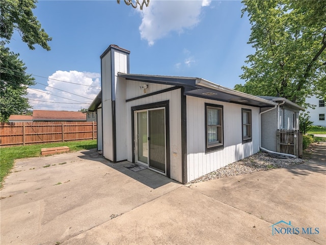 1323 Richland St, Maumee, OH 43537 - rear view of house with a patio area and a chimney