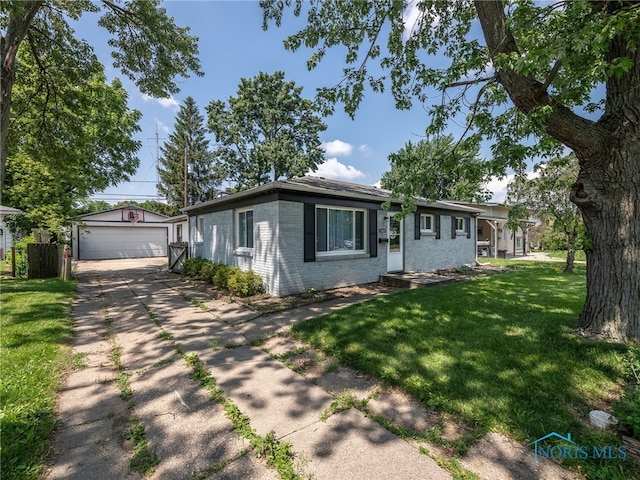 1323 Richland St, Maumee, OH 43537 - ranch-style home featuring an outdoor structure, a detached garage, a front yard, and brick siding