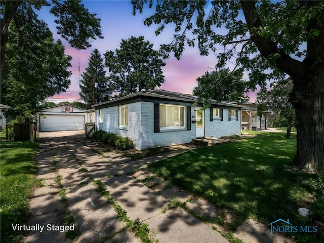 1323 Richland St, Maumee, OH 43537 - ranch-style home featuring an outbuilding, brick siding, a detached garage, and a yard