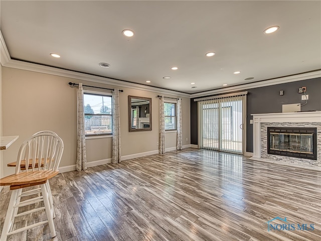 1323 Richland St, Maumee, OH 43537 - unfurnished living room featuring ornamental molding, recessed lighting, wood finished floors, and a fireplace with flush hearth
