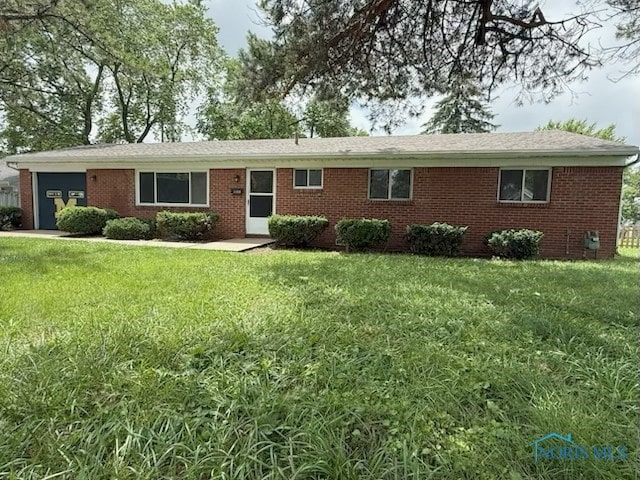 1137 Michigan Ave, Maumee, OH 43537 - ranch-style home with a garage, brick siding, and a front yard