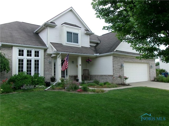 26608 Amberwood Dr, Perrysburg, OH 43551 - traditional home featuring brick siding, a front yard, concrete driveway, an attached garage, and covered porch
